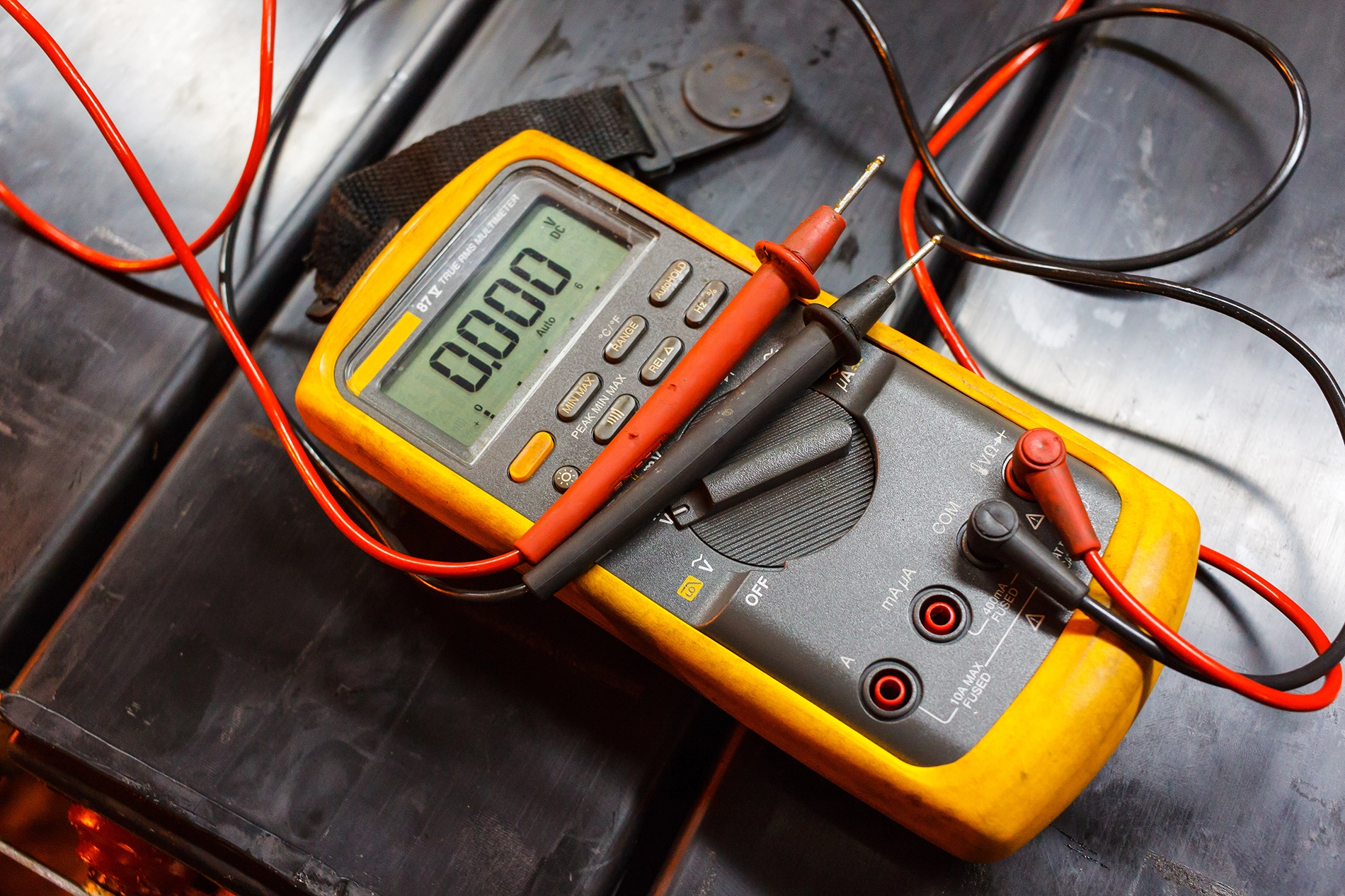 Multimeter measuring resistance on an ATEX vacuum hose