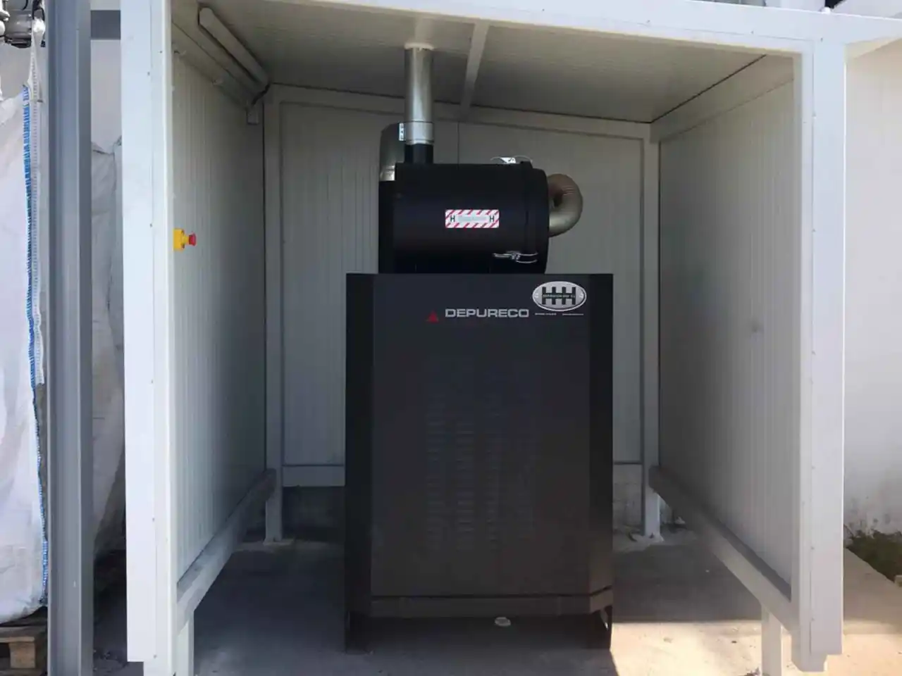 Pump station housed in a noise enclosure outside the production area