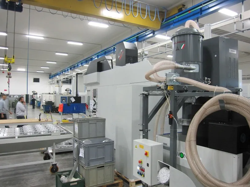 HF stationary central system installed alongside a CNC machine