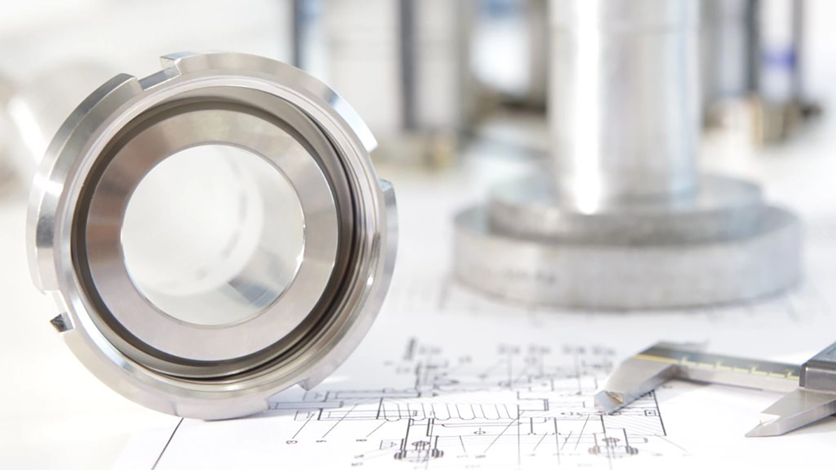 Stainless steel coupling on an engineering drawing with calipers