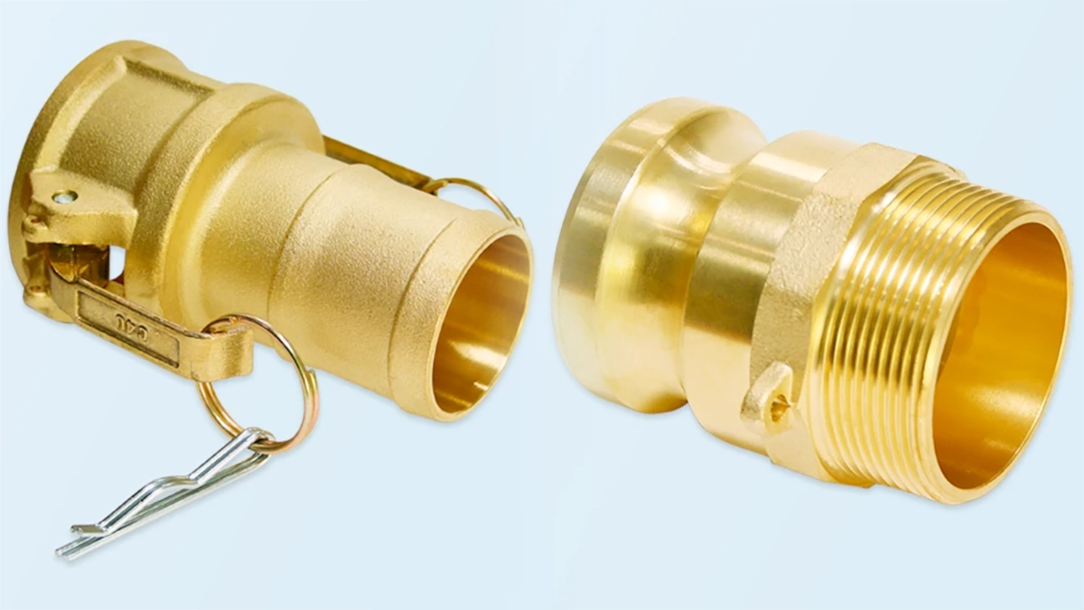 Two brass camlock couplings photographed on a light blue background