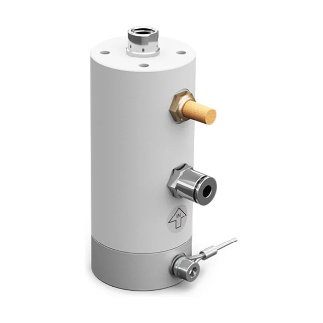 An adjustable piston vibrator with a white nylon housing on a grey base, seen from the front at an angle, with a brass silencer, a steel air connection and a short shaft on top.