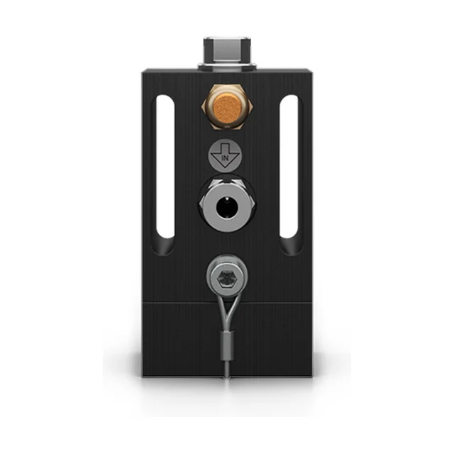 An adjustable piston vibrator with a square black aluminium housing, seen from the front: two long slots in the face, a brass silencer, a steel air connection and an arrow marked IN embossed in the housing.