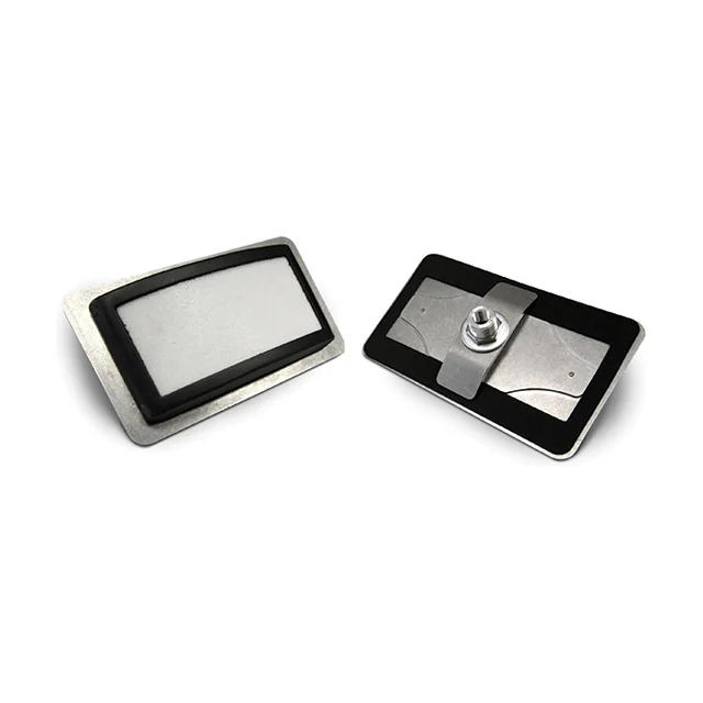 An I100 pad mounted on a stainless plate with a black gasket frame, seen from the front and the back.