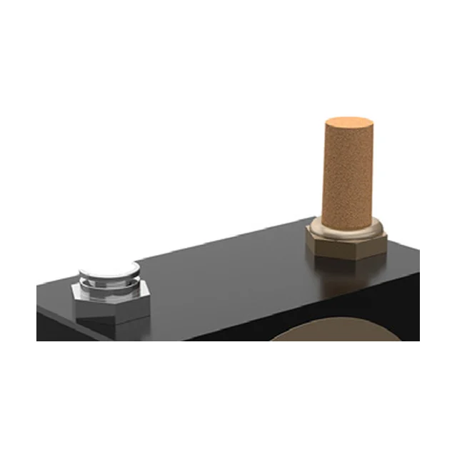 The top face of a black roller vibrator with two connections, one at each end. On the left a bright metal push-in fitting, on the right a brass nut with a sintered bronze silencer screwed into it. At the bottom the edge of the round brass cover is visible.